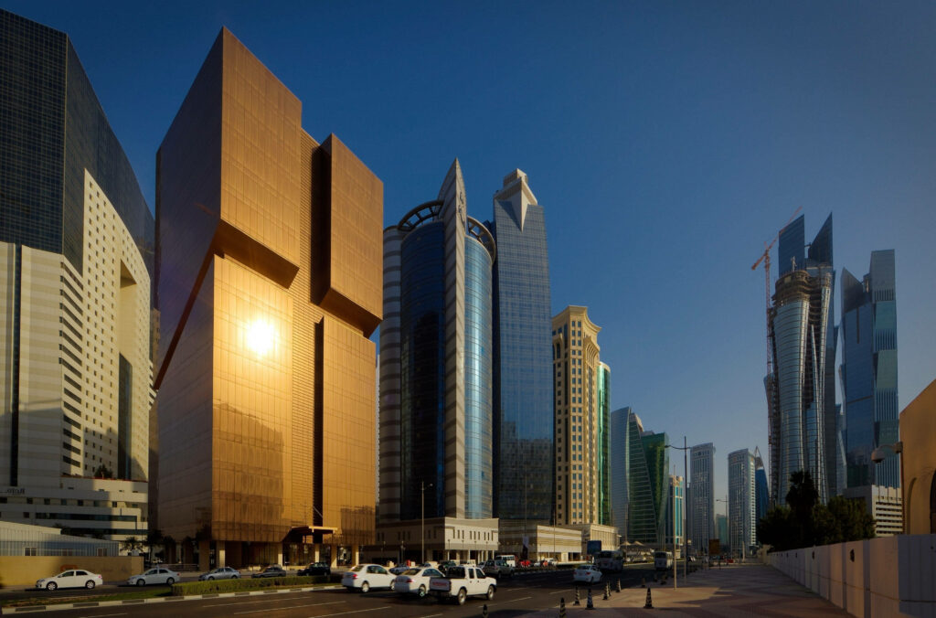 Stunning Doha Cityscape Wallpaper: Sunlit Bronze-Hued Architecture