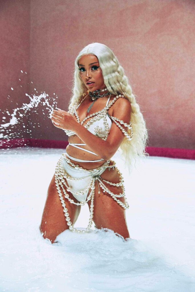 Elegant Doja Cat in Luxurious Milk Bath - Stunning Wallpaper Background