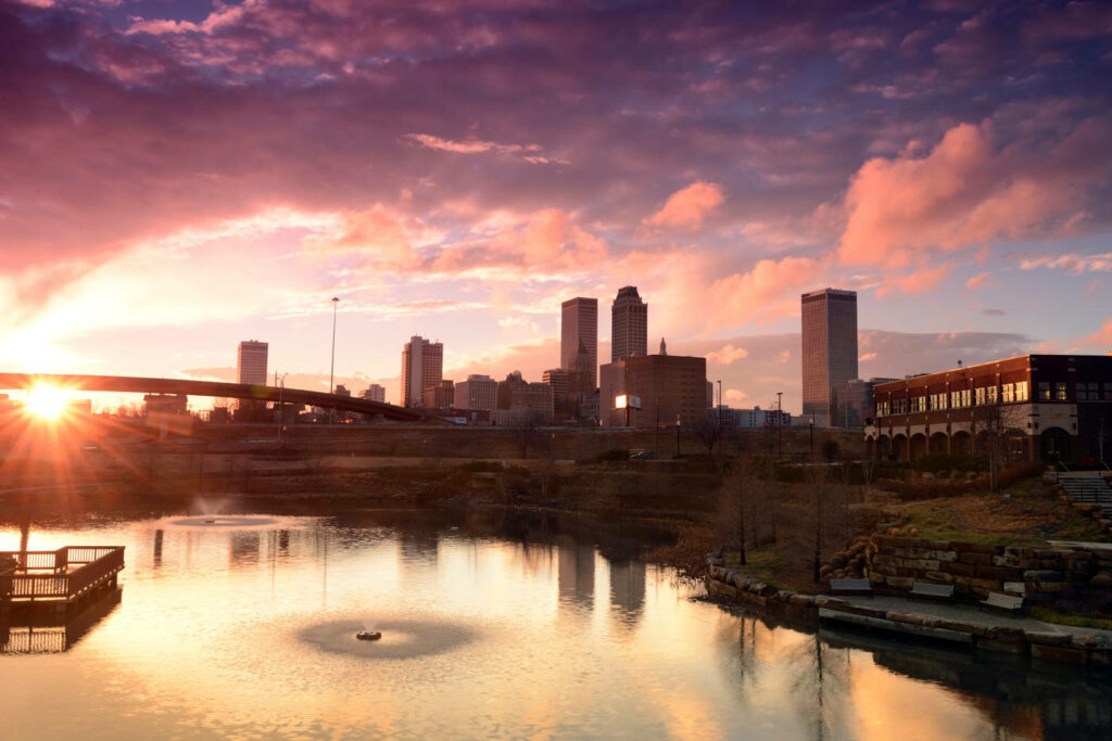 Tranquil Downtown Tulsa Sunset Wallpaper with Iconic Skyline Reflection