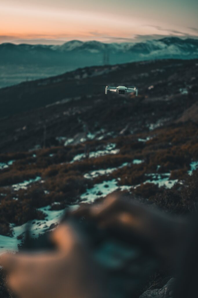 Stunning Drone Wallpaper: Quadrocopter Over Rugged Mountains at Sunset