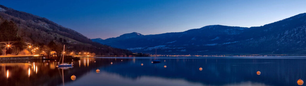 Serene Lakeside Dusk Dual Monitor Wallpaper - Stunning Mountain Reflections