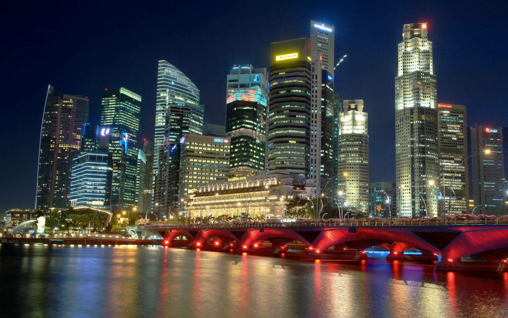 Stunning Evening Cityscape: Illuminated Red Bridge & Modern Skyscrapers Wallpaper