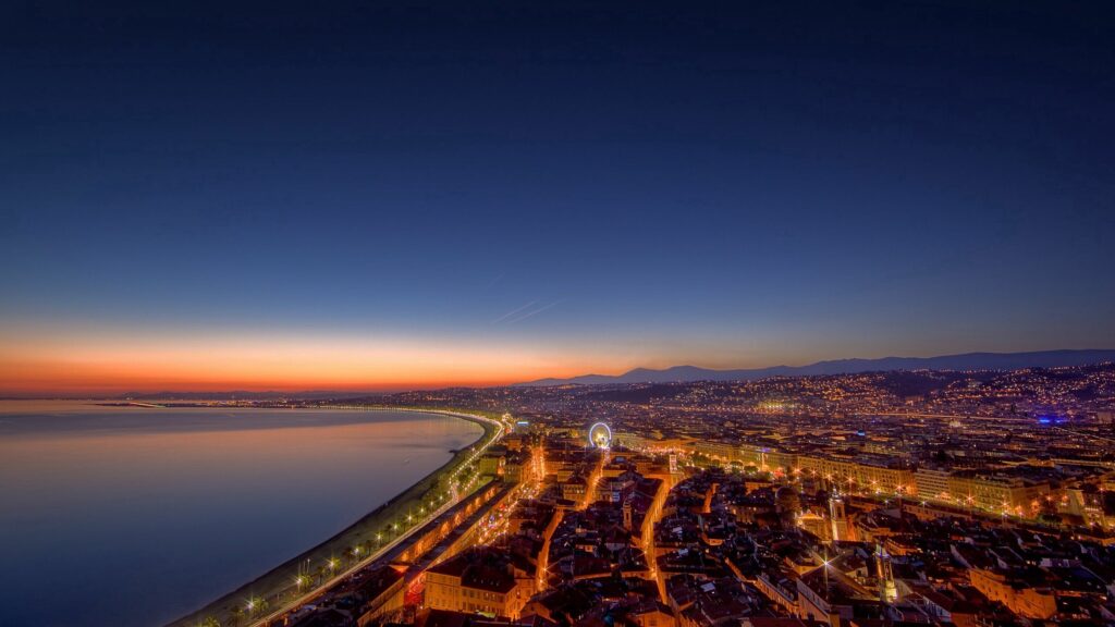 Stunning Evening Cityscape Wallpaper: Sunset Sky & Glowing Coastline