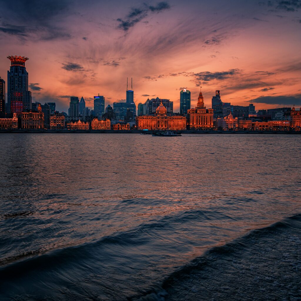 Stunning Evening Cityscape Wallpaper with Vibrant Skyline Reflections