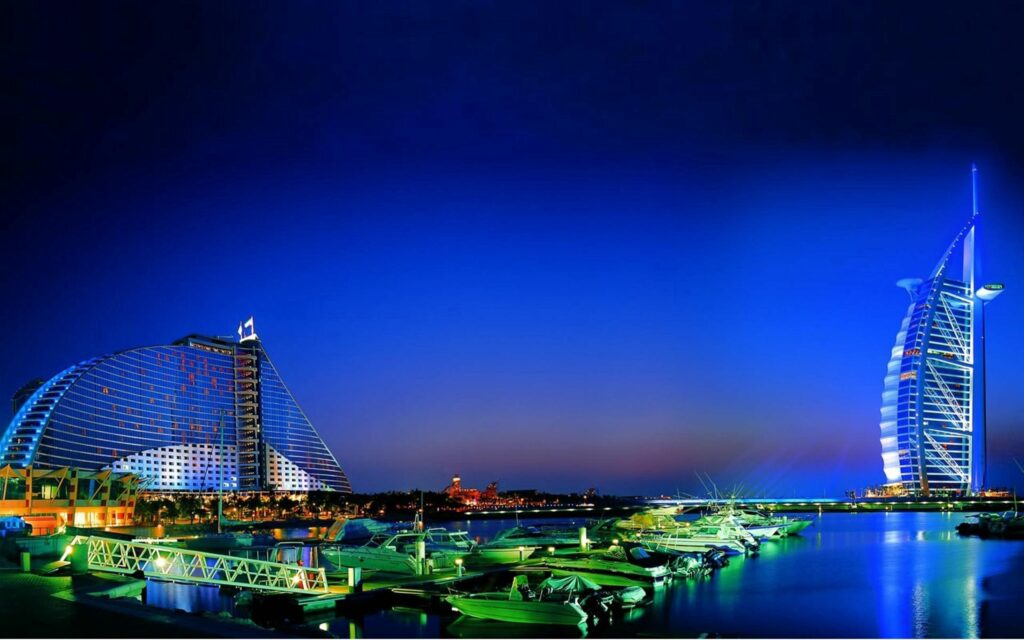 Evening Dubai Wallpaper: Illuminated Skyline & Serene Water Reflections