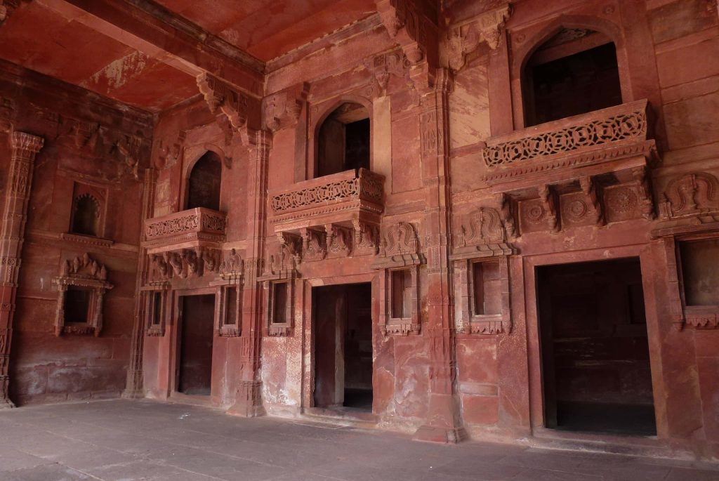 Fatehpur Sikri red sandstone Mughal architecture wallpaper with ornate balconies and arches