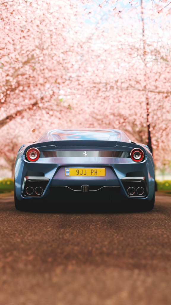 Ferrari F12 Wallpaper: Iconic Sports Car Amid Cherry Blossoms