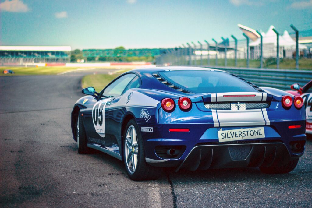 Sleek Blue Ferrari Wallpaper: Aerodynamic Design on Silverstone Track