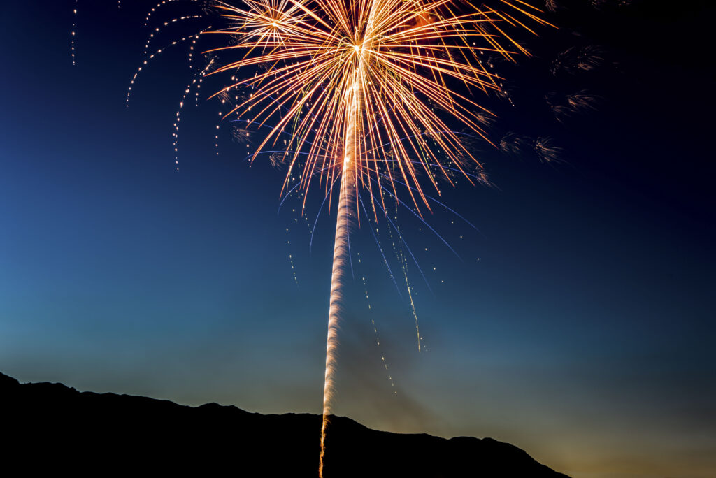 Stunning Firework Salute Wallpaper: Night Sky & Mountain Silhouette