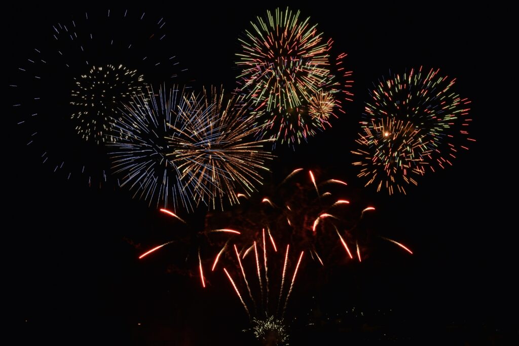 Vibrant Fireworks Night Sky Wallpaper - Festive Holiday Background