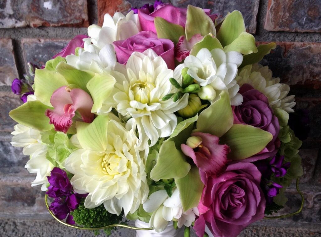 Vibrant Flower Bouquet Wallpaper on Rustic Brick Background
