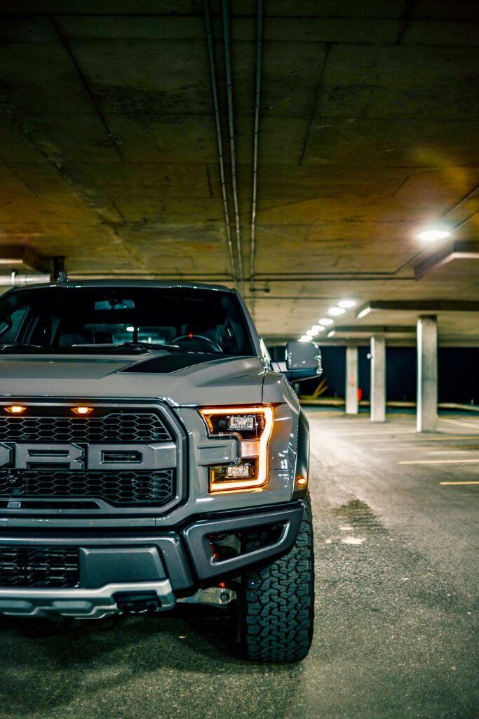 Ford Raptor Front View: Gray SUV in Garage Parking Area Wallpaper
