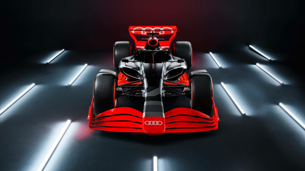 High-resolution wallpaper of sleek red and black Audi Formula One car under dramatic lighting