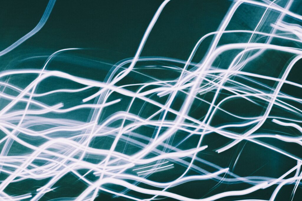 Stunning Freezelight Wallpaper: Wavy Glowing Lines on Dark Background