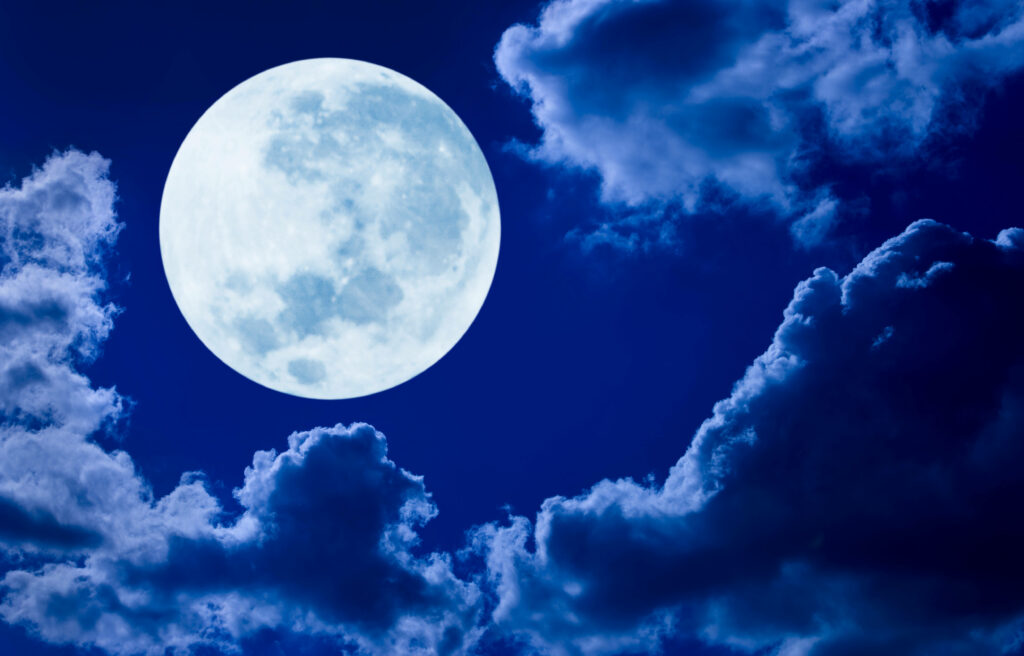 Luminous Full Moon Wallpaper: Glowing Blue Night Sky Background