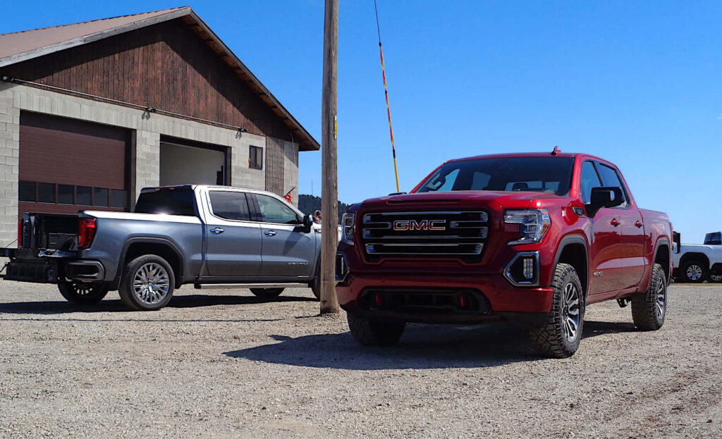 Bold GMC Sierra Wallpaper: Rugged Pickup Against Rustic Backdrop