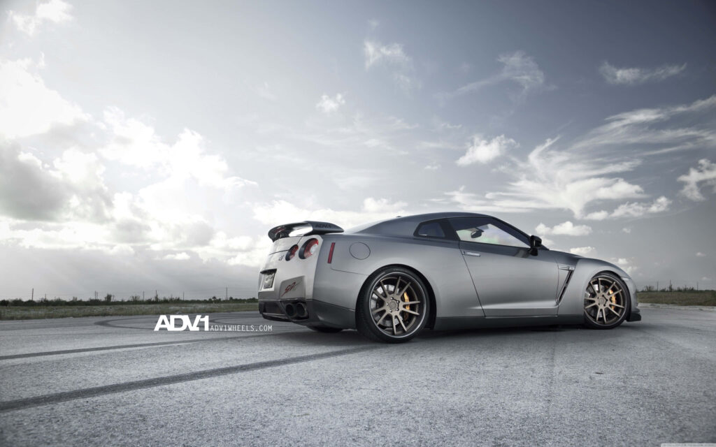 Sleek Silver GT-R Wallpaper: Stunning Automotive Runway Design