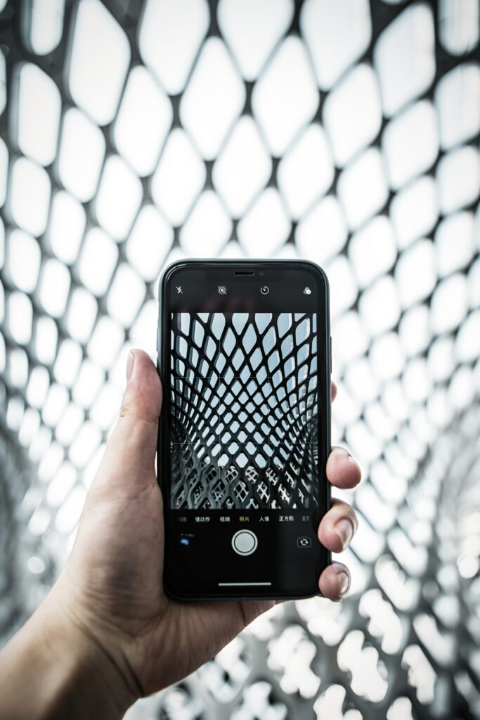 Dynamic Geometric Pattern: Hand & Smartphone Wallpaper Background