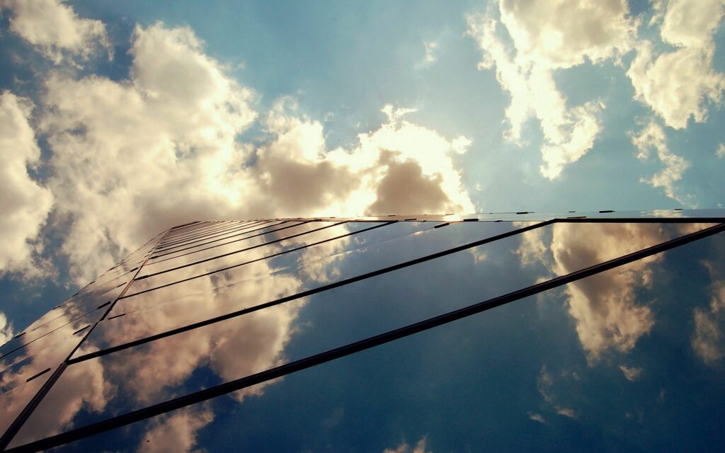 Stunning Glass Building Reflection Wallpaper: Sky & Clouds Aesthetic