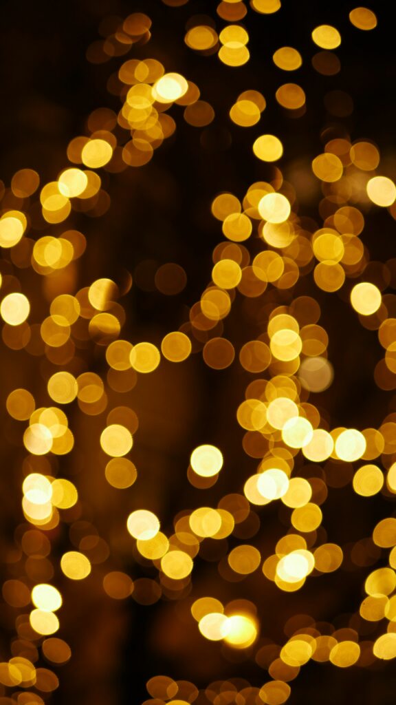 Stunning Golden Bokeh Wallpaper: Mesmerizing Glow on Dark Background