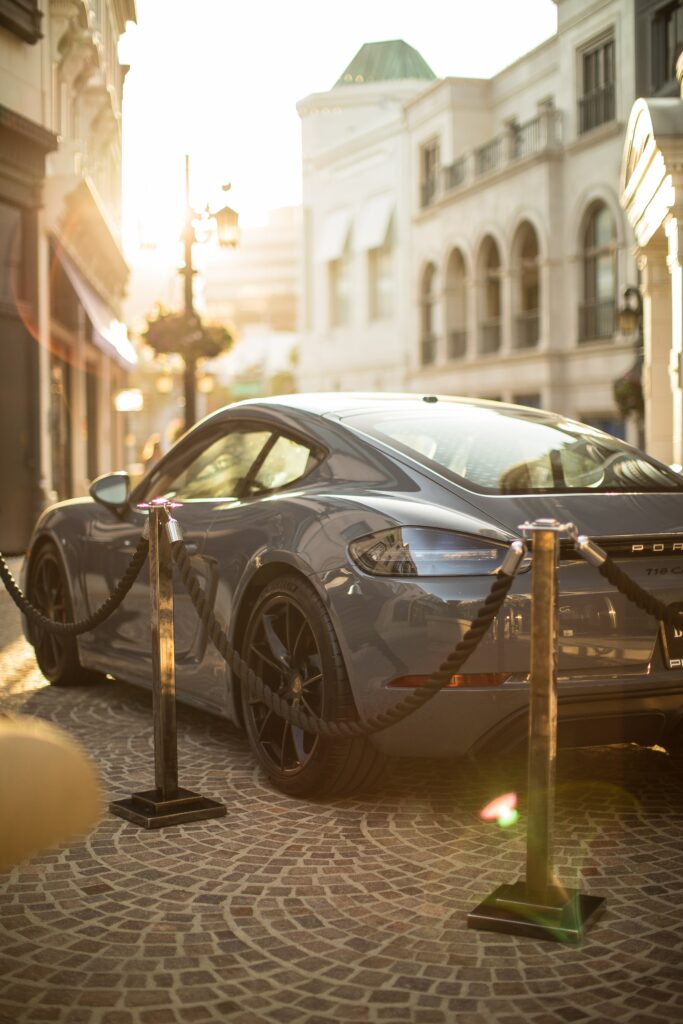Sleek Gray Porsche 718 Coupe on Cobblestone Street Wallpaper