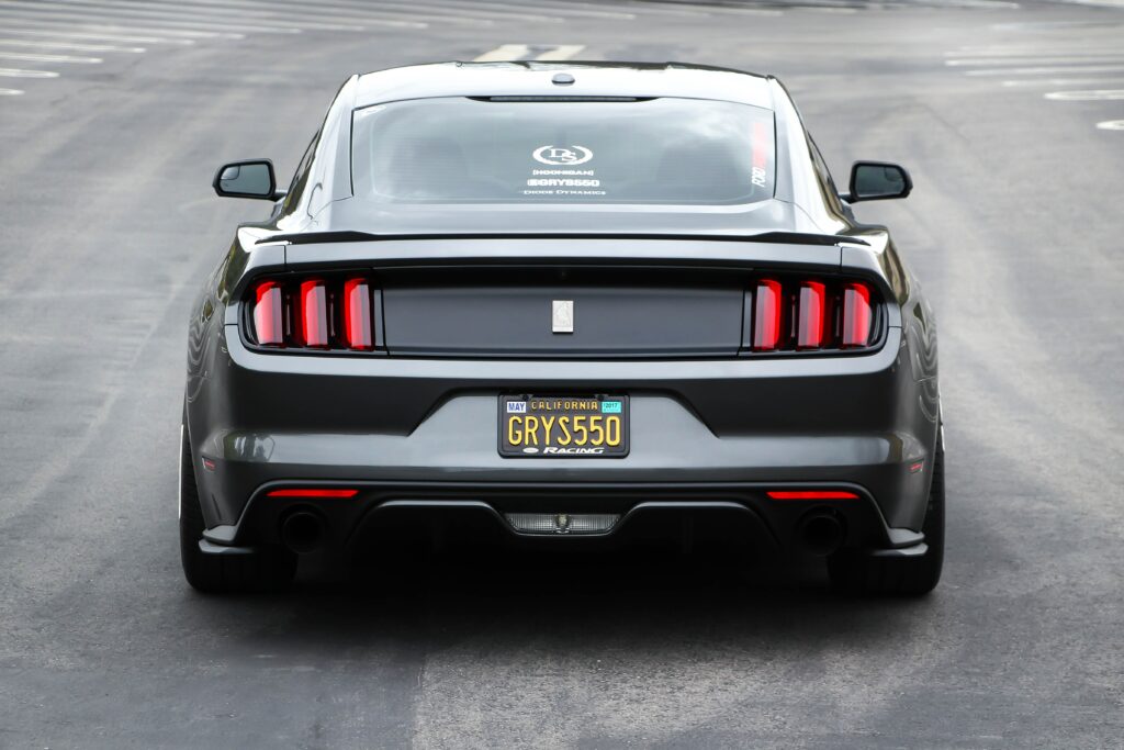 Sleek Gray Sports Car Rear View in Urban Setting - Wallpaper