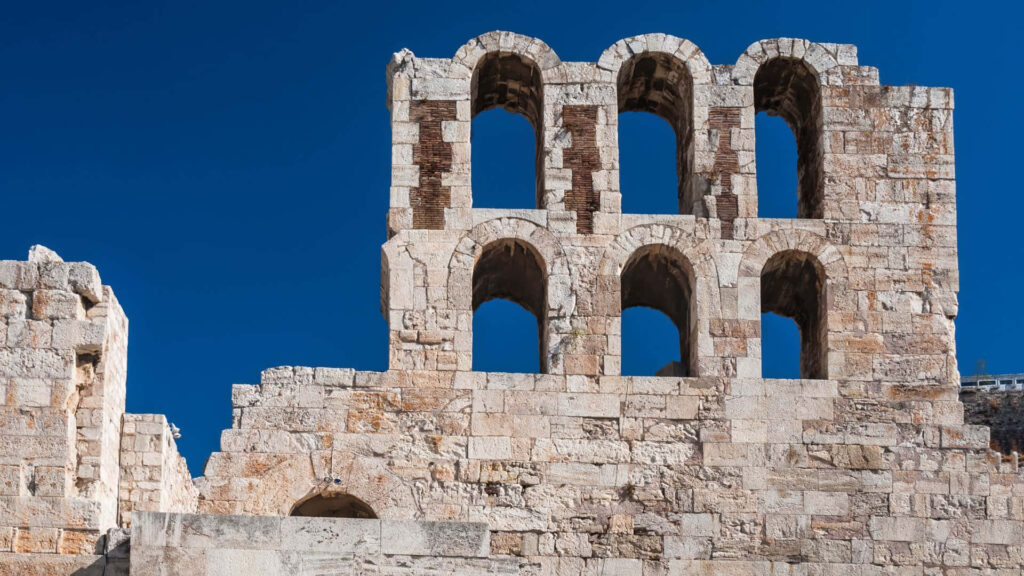 Stunning Greece Wallpaper: Ancient Architecture Under Clear Blue Sky