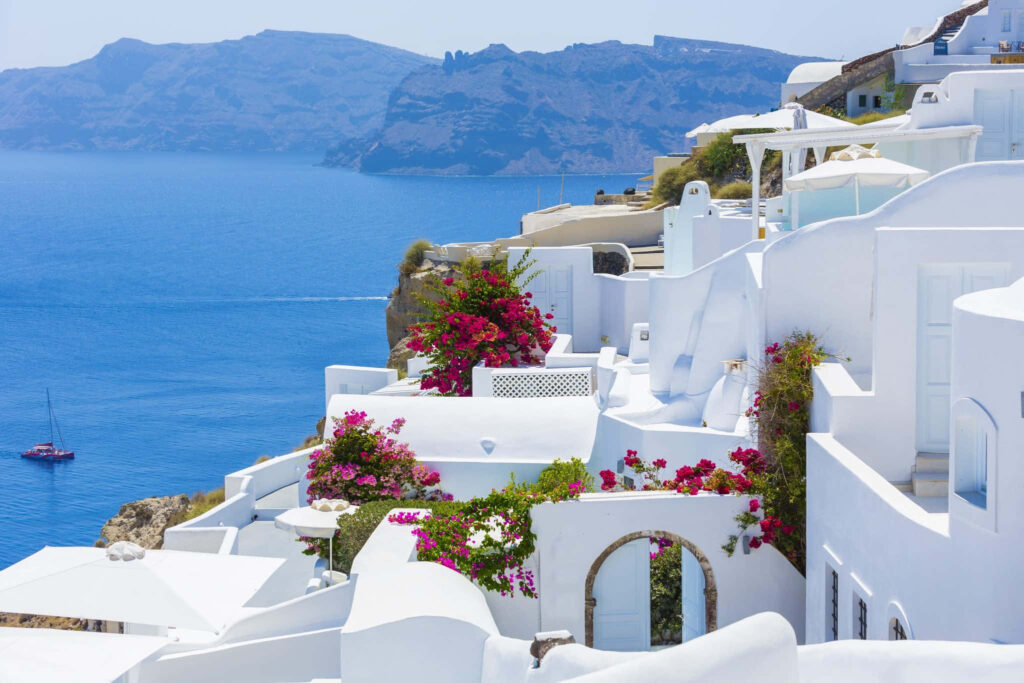 Stunning Greek White Building with Flowers - Wallpaper Background