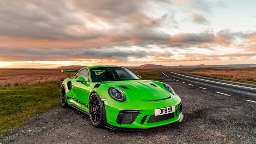Stunning Green Porsche GT3 RS Wallpaper Against Sunset Background