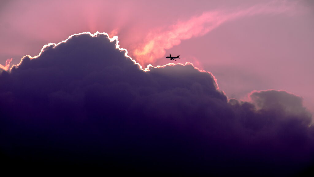 Stunning HD Airplane Silhouette Wallpaper with Dramatic Sunset Clouds