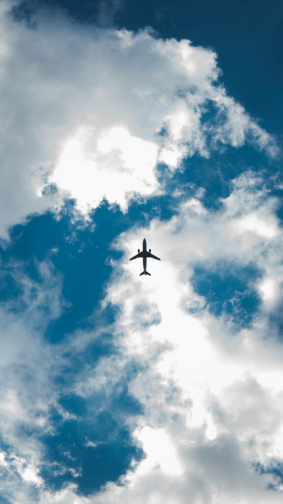 Stunning HD Airplane Wallpaper: Vibrant Blue Sky & Clouds Background