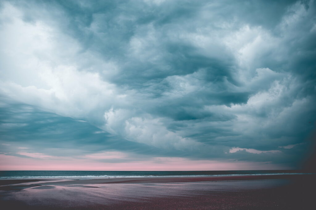 Stunning HD Beach Scene Wallpaper: Serene Sea & Dramatic Clouds