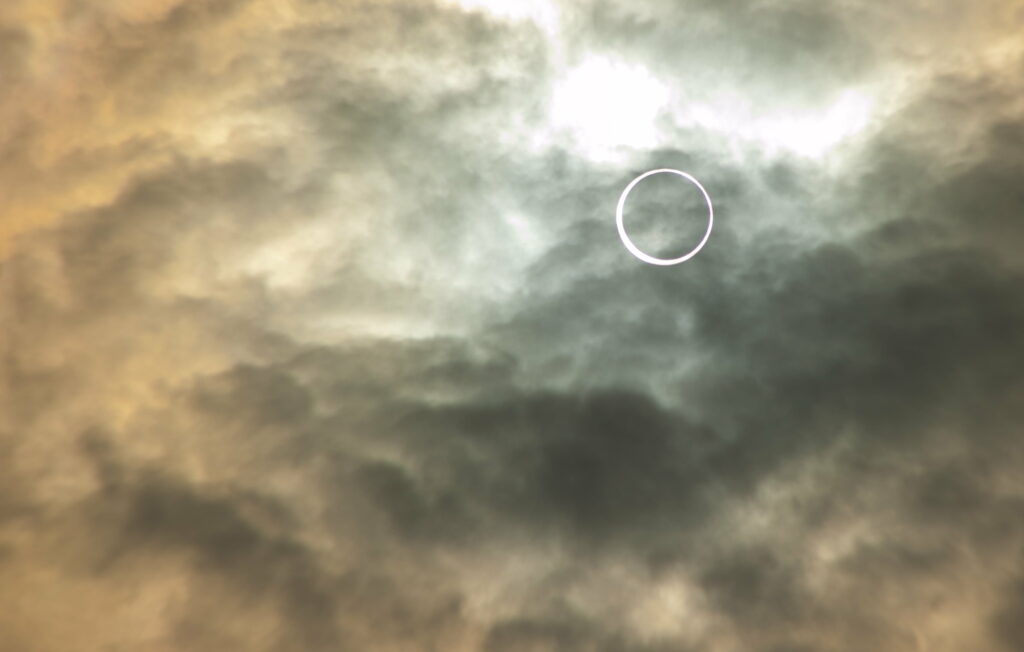 Moody Eclipse Sky Wallpaper: Swirling Clouds & Ethereal Atmosphere