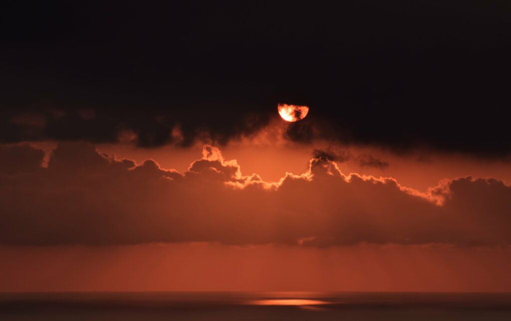 Stunning Sunset Wallpaper with Dark Clouds and Reddish Sky Glow