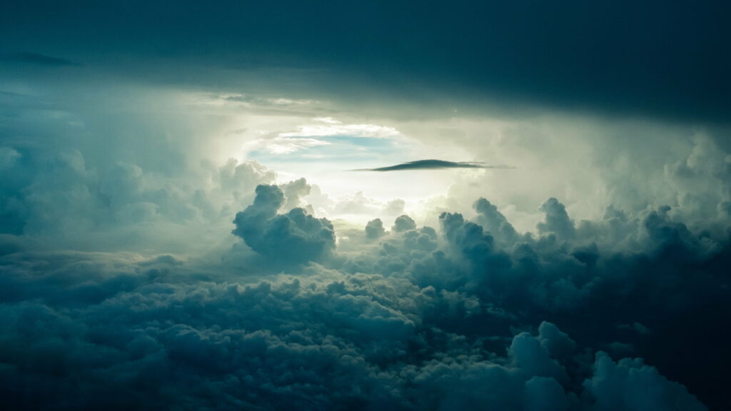Stunning HD Background: Dramatic Clouds and Celestial Sunlight Wallpaper