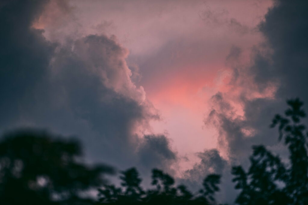 Stunning HD Wallpaper: Dramatic Sunset Sky with Dark Clouds & Trees