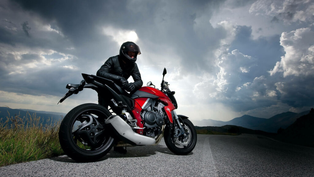 Stunning HD Wallpaper: Red Motorcycle on Scenic Winding Road