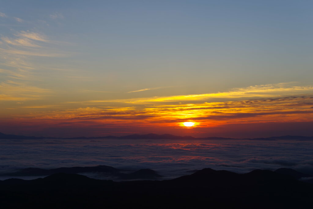 Vivid Sunset HD Wallpaper: Serene Mountain View with Orange Glow