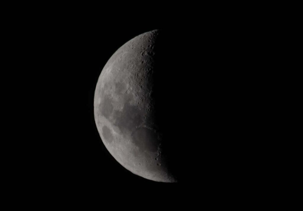 Stunning Half Moon Close-Up: Dark Minimalist Wallpaper Background