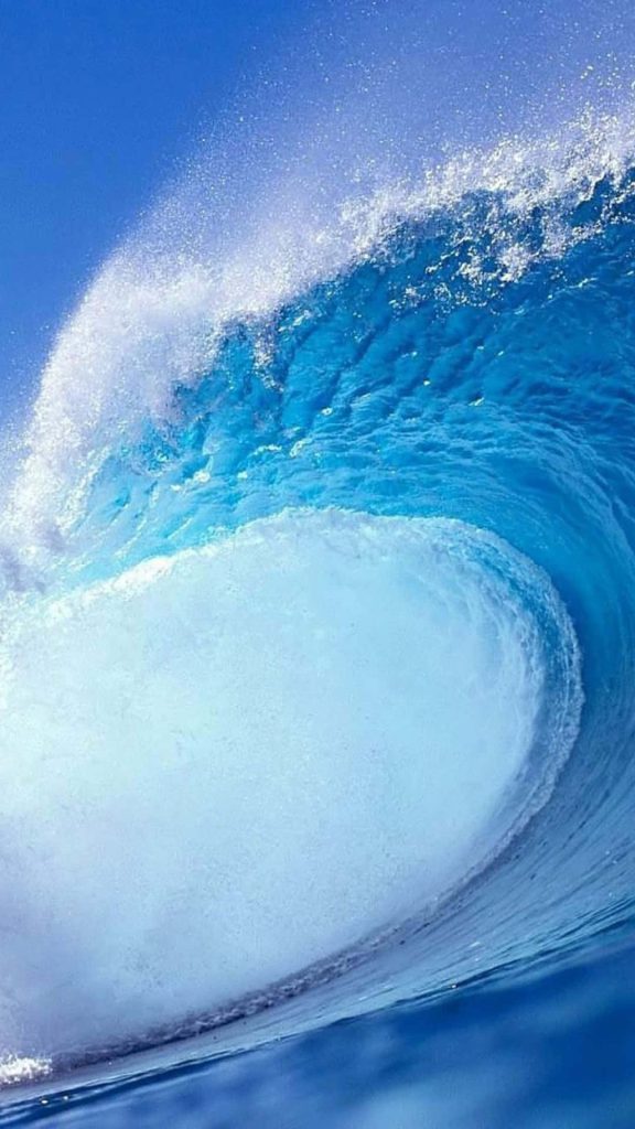 High-definition ocean wave curling with deep blue and seafoam perfect for serene wallpaper