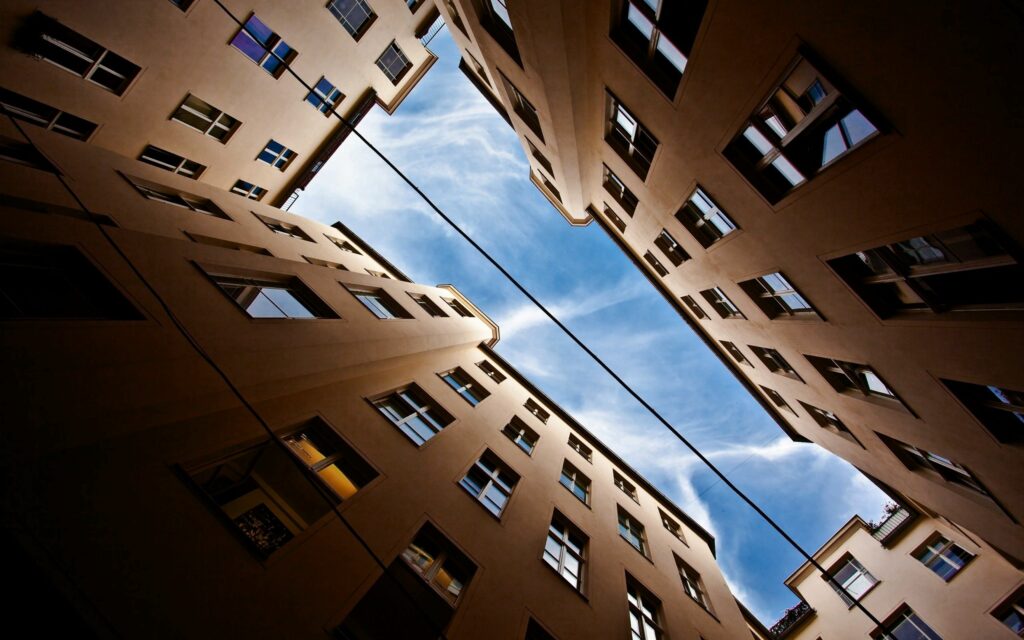 Stunning Upward View of High-Rise Buildings - Wallpaper Background
