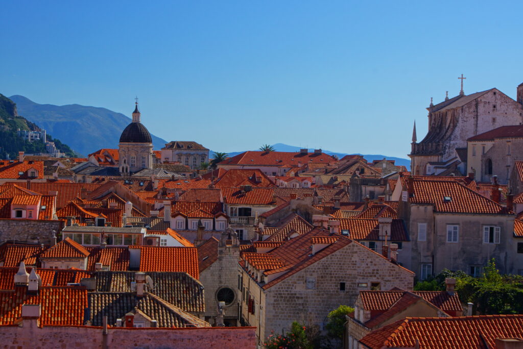 Stunning Historic Cityscape Wallpaper with Red-Tiled Roofs & Towers