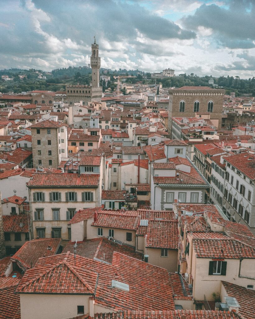 Historic Cityscape Wallpaper: Red-Tiled Rooftops & Majestic Architecture