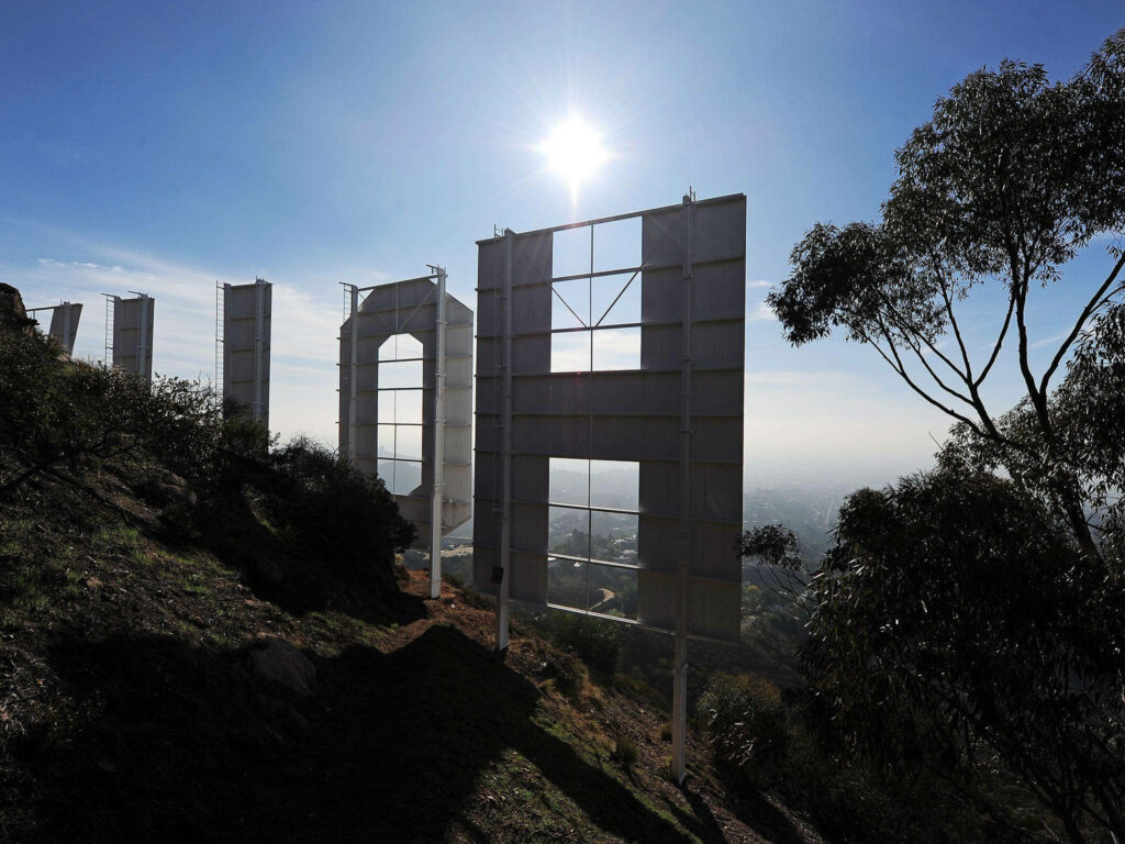 Stunning Hollywood Sign View: Sunlit Greenery Wallpaper Background