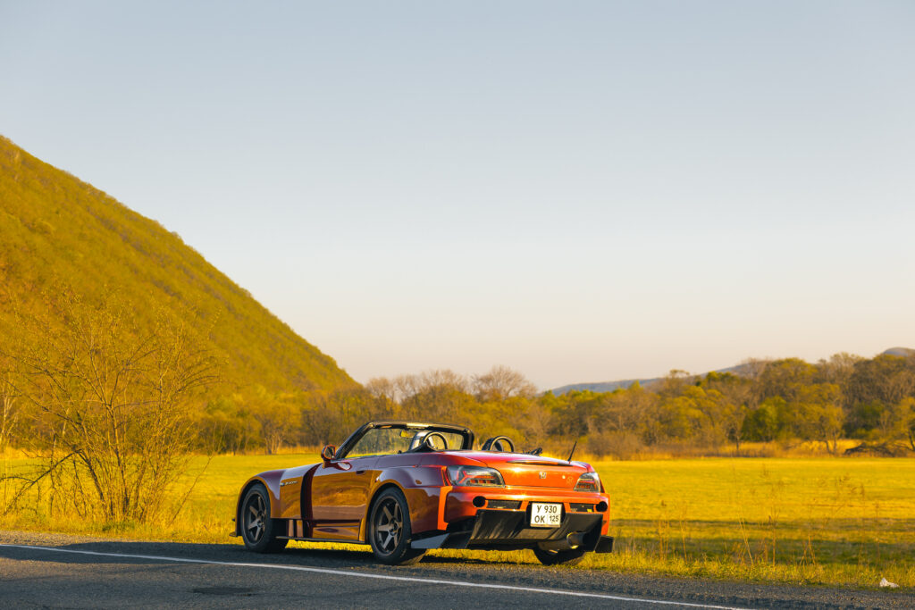 Red Honda S2000 Sports Car Against Scenic Landscape Wallpaper