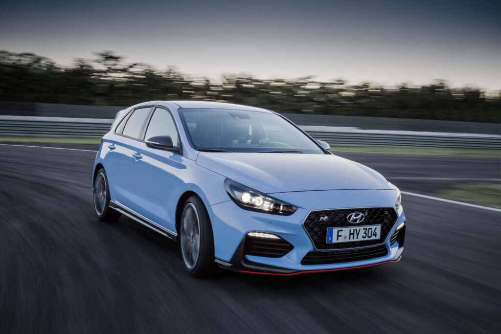 High-Speed Hyundai Car on Racetrack: Dynamic Design Wallpaper