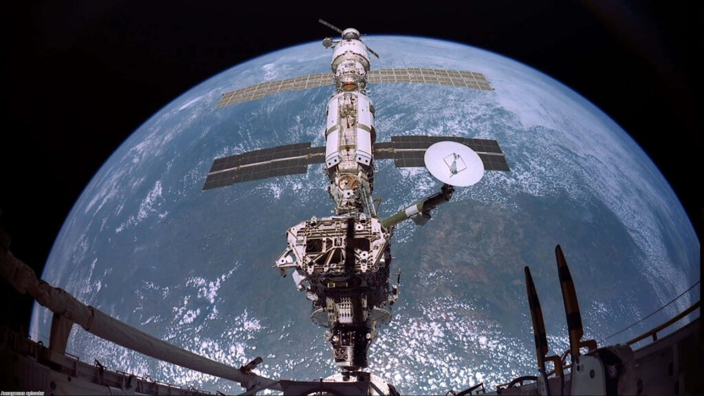 Stunning ISS Orbiting Earth Wallpaper: Vibrant Blue Background