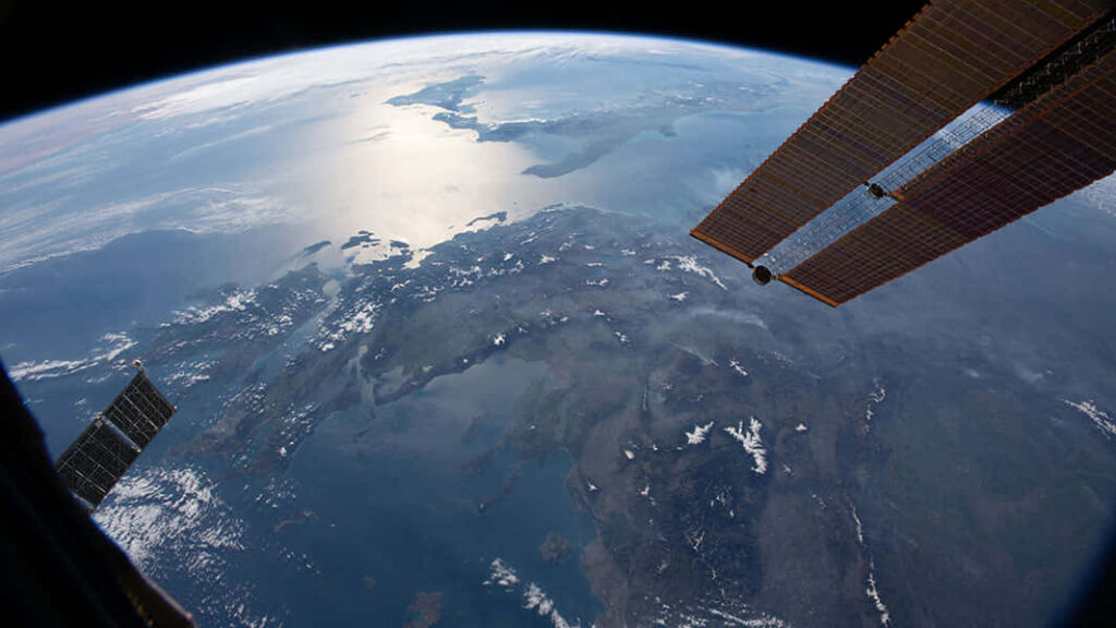 Stunning Earth View from ISS: Astronaut Collaboration Wallpaper Background