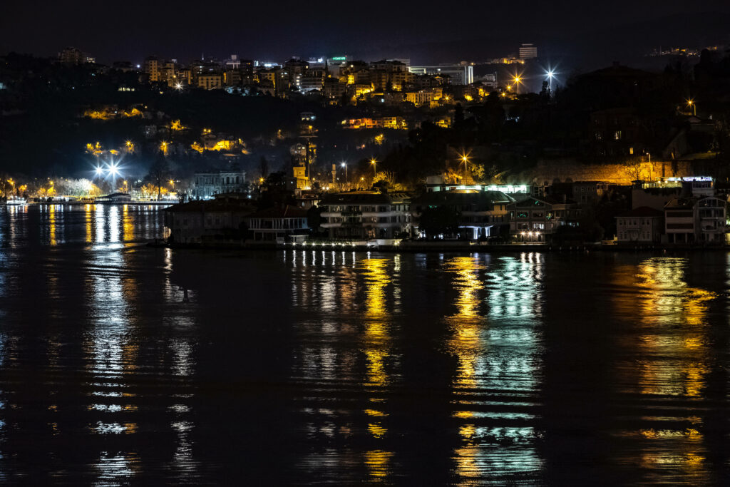 Stunning Istanbul Nighttime View: Illuminated Buildings & Water Reflections Wallpaper