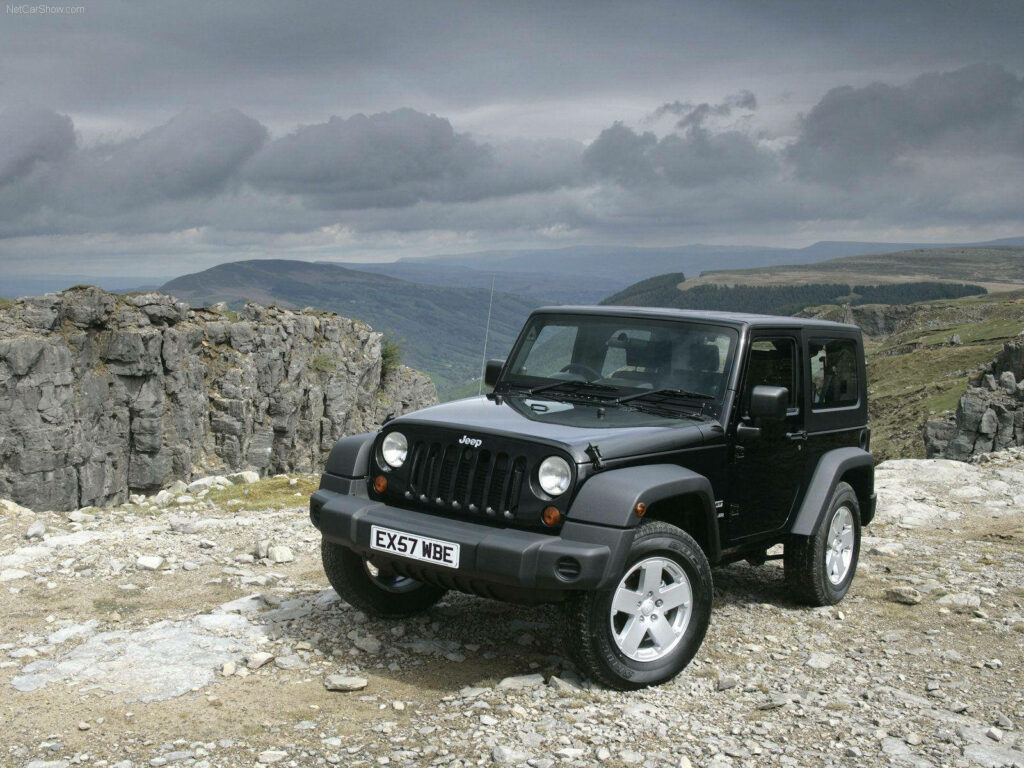 Adventure Wallpaper: Black Jeep Wrangler on Rocky Cliff Landscape